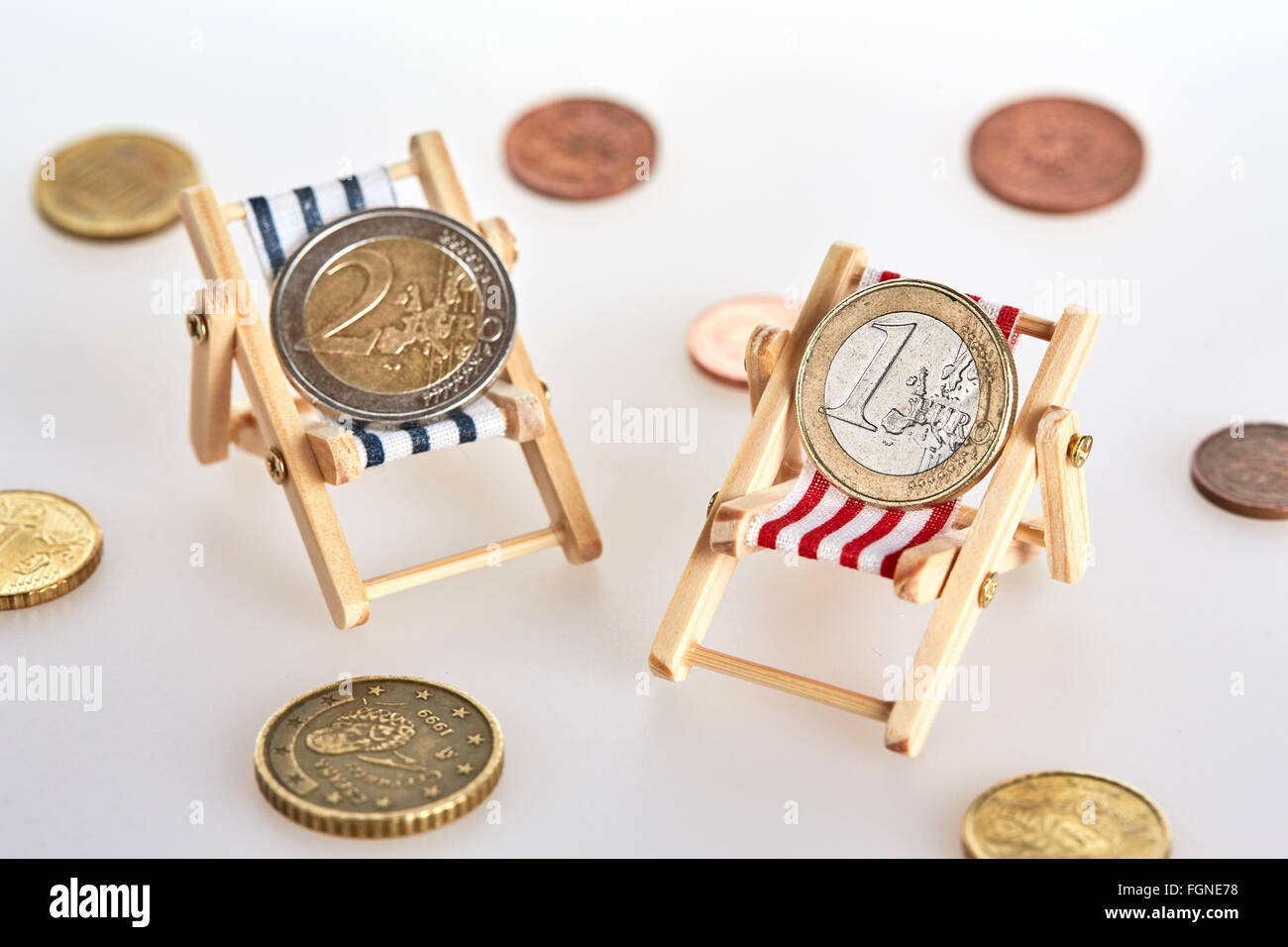 Savings for retirement lying relaxed on two deckchairs Stock Photo