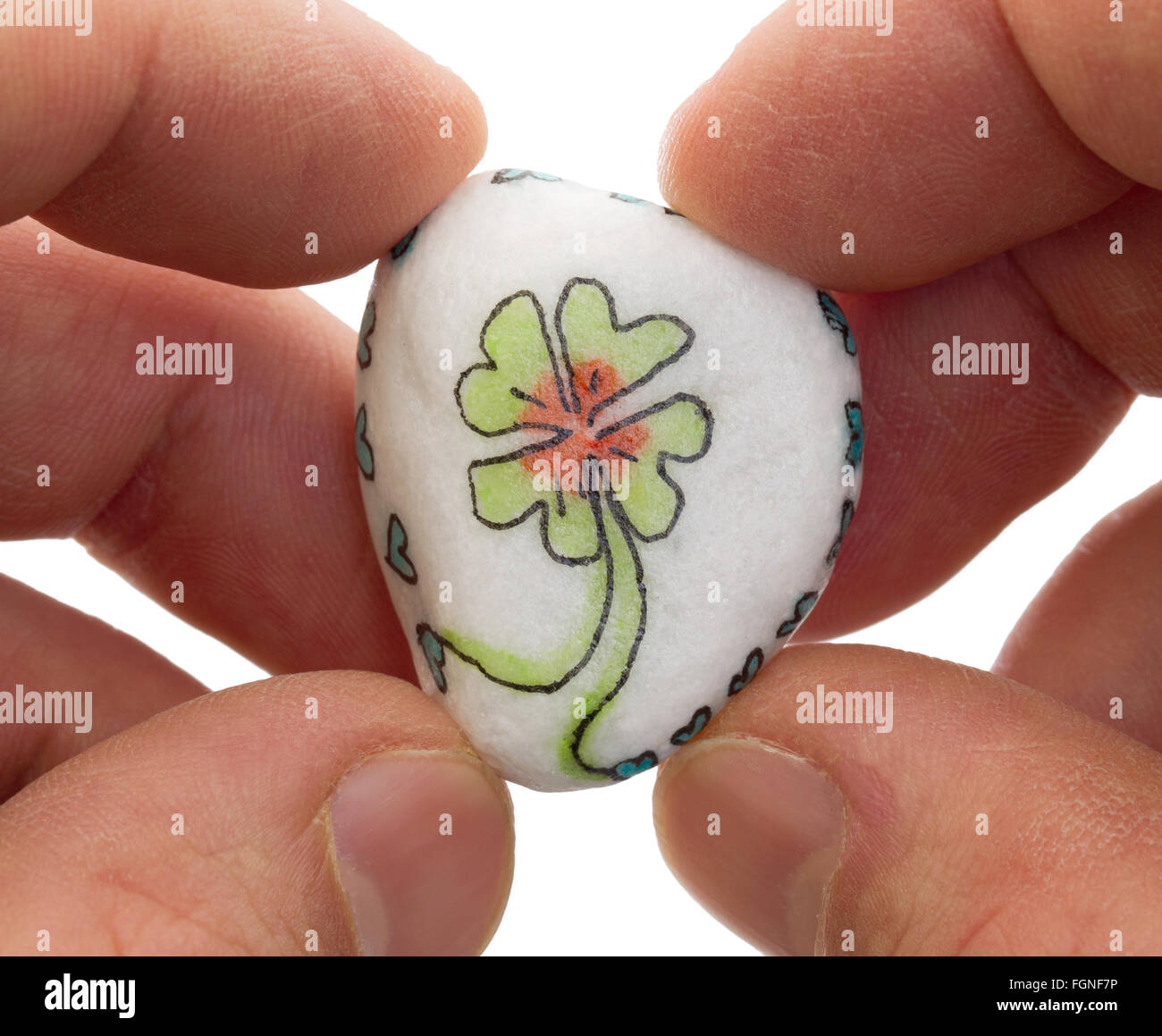 Stone with drawing of a clover four and small hearts, isolated Stock Photo