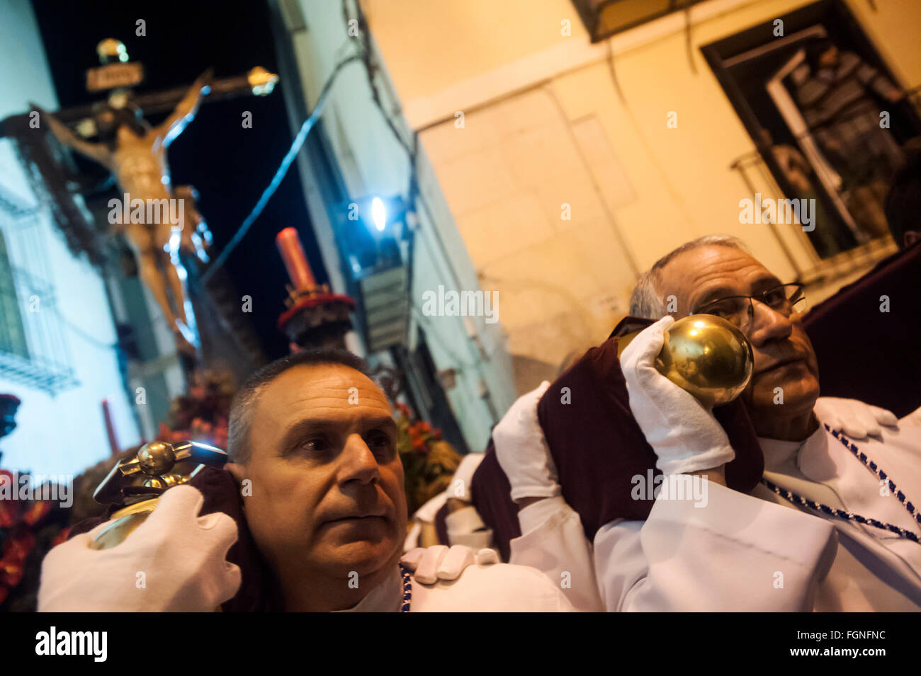 Two costaleros in the sea procession of Christ in the old town of Alicante Stock Photo
