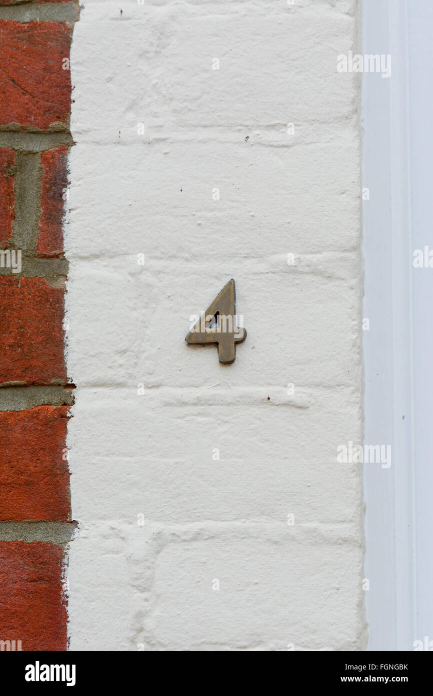 House number 4 sign on wall Stock Photo