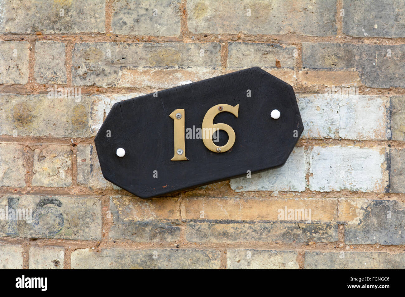 House number 16  sign on wall Stock Photo