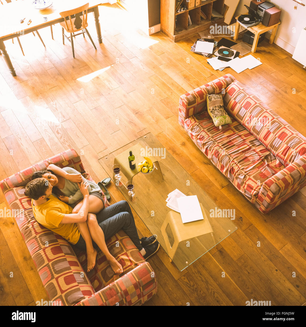 Young couple cuddling on the couch Stock Photo Alamy