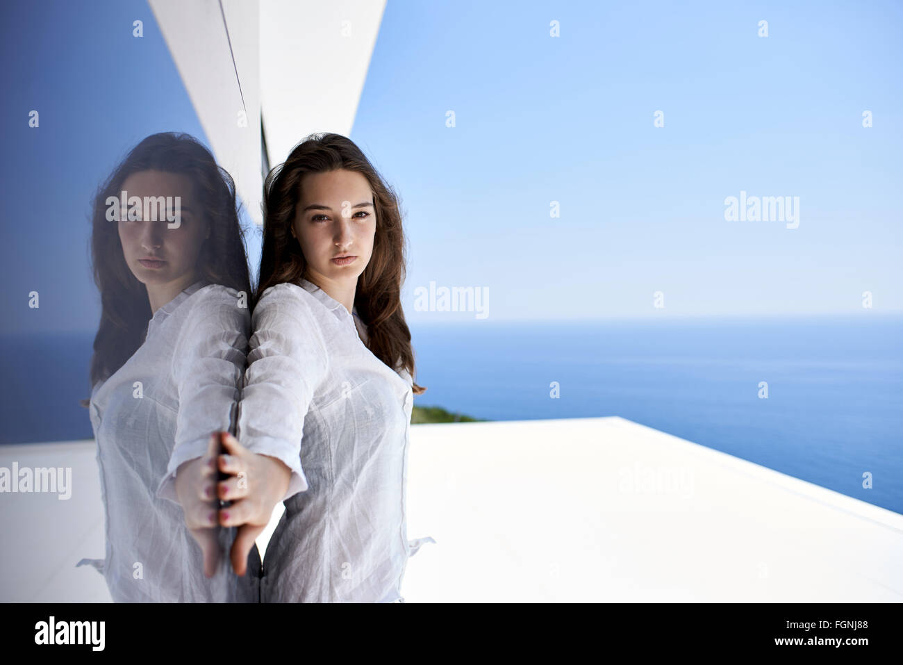 relaxed woman in front of luxury modern home Stock Photo - Alamy