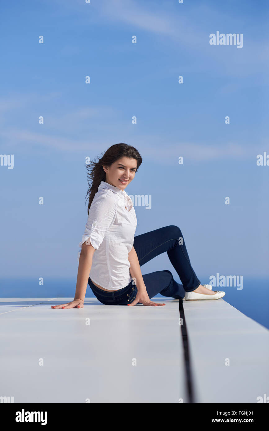 relaxed woman in front of luxury modern home Stock Photo - Alamy