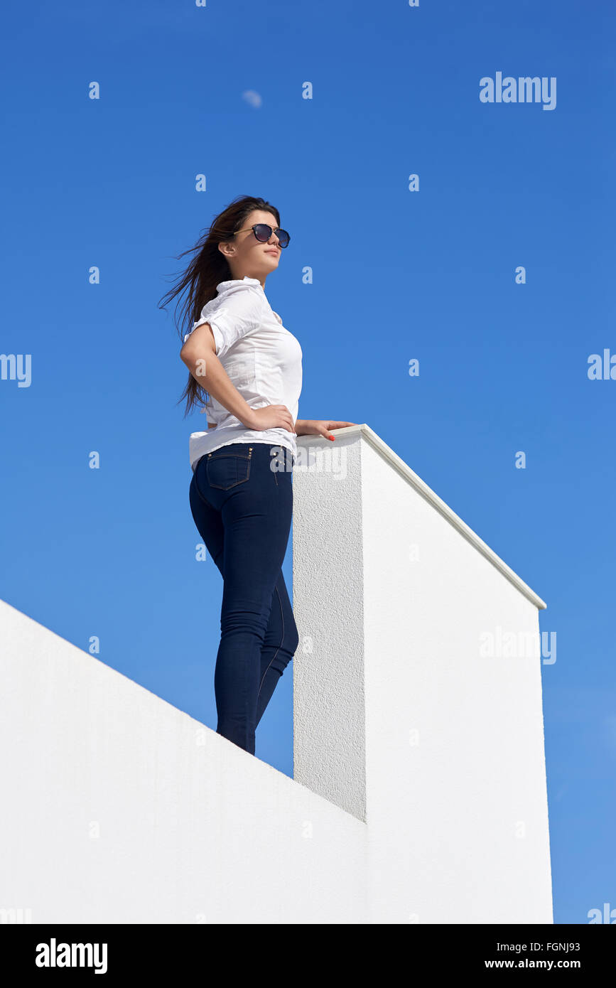 relaxed woman in front of luxury modern home Stock Photo - Alamy
