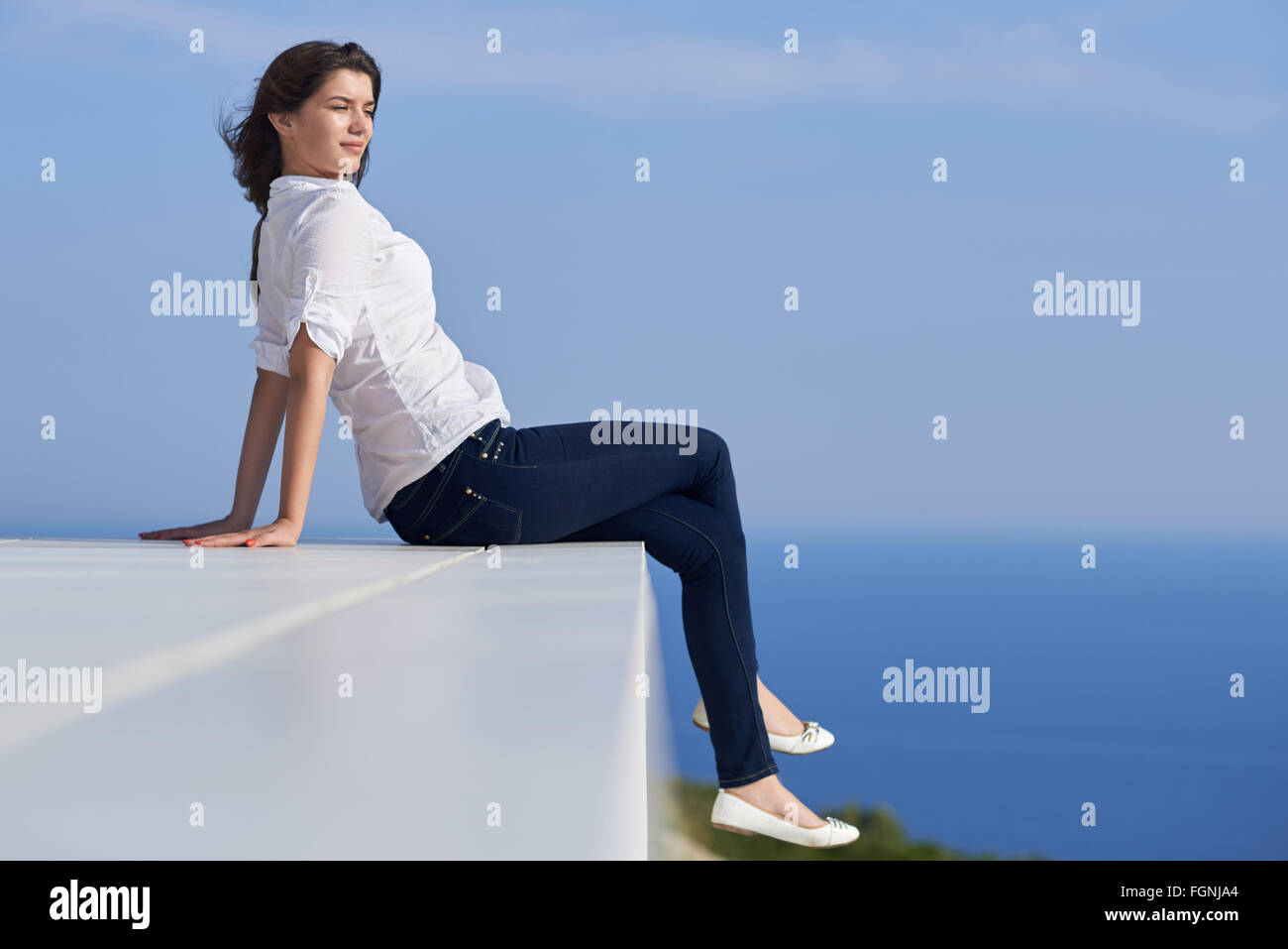 relaxed woman in front of luxury modern home Stock Photo - Alamy