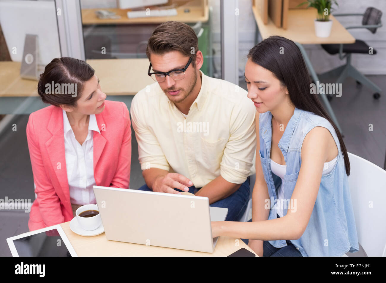 Business team using laptop and having coffee Stock Photo - Alamy