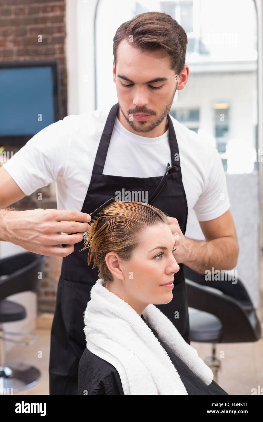 Handsome hair stylist with client Stock Photo - Alamy