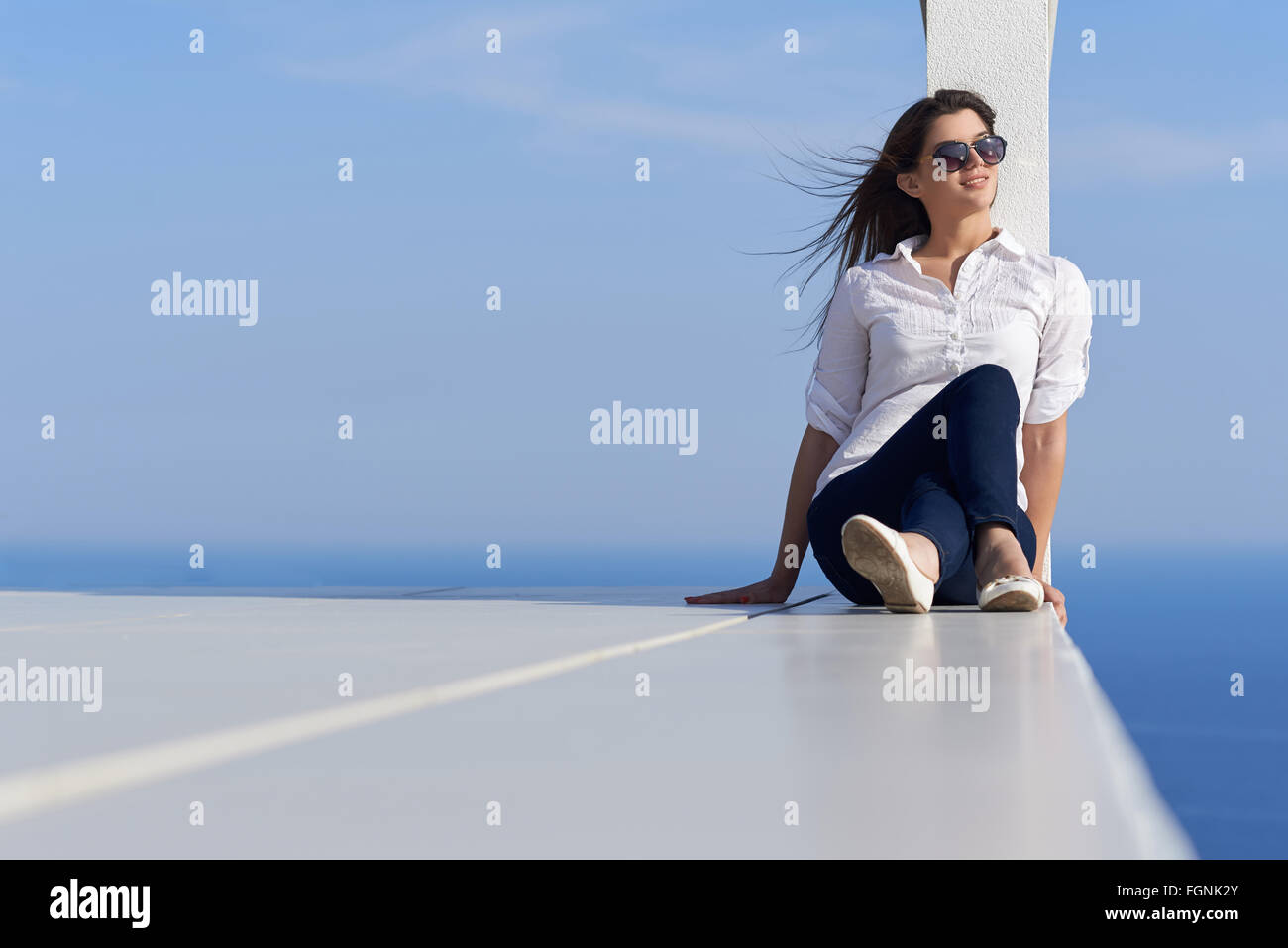 relaxed woman in front of luxury modern home Stock Photo - Alamy