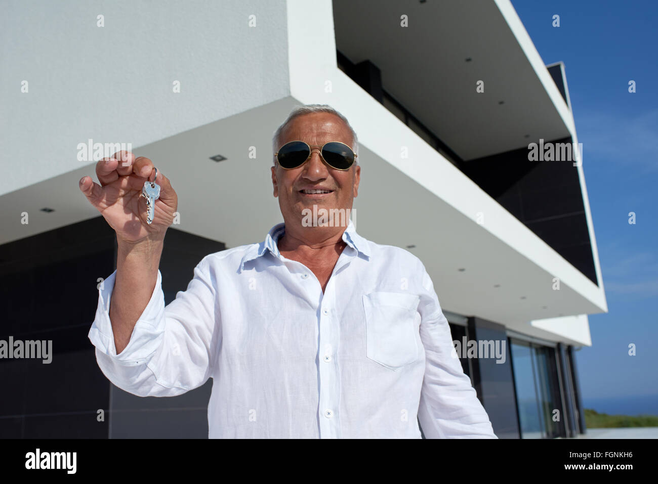 senior man in front of modern home Stock Photo