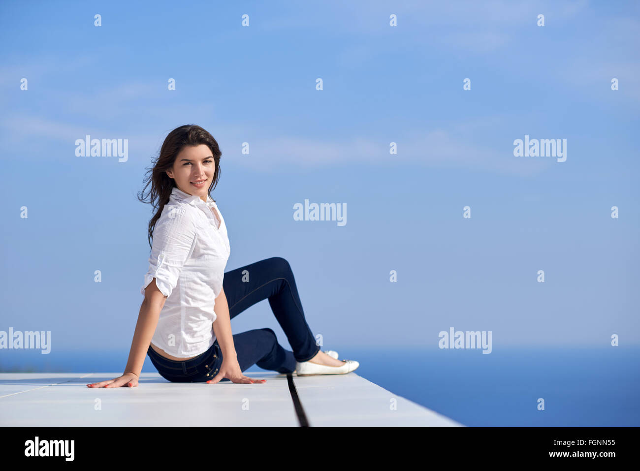 relaxed woman in front of luxury modern home Stock Photo - Alamy