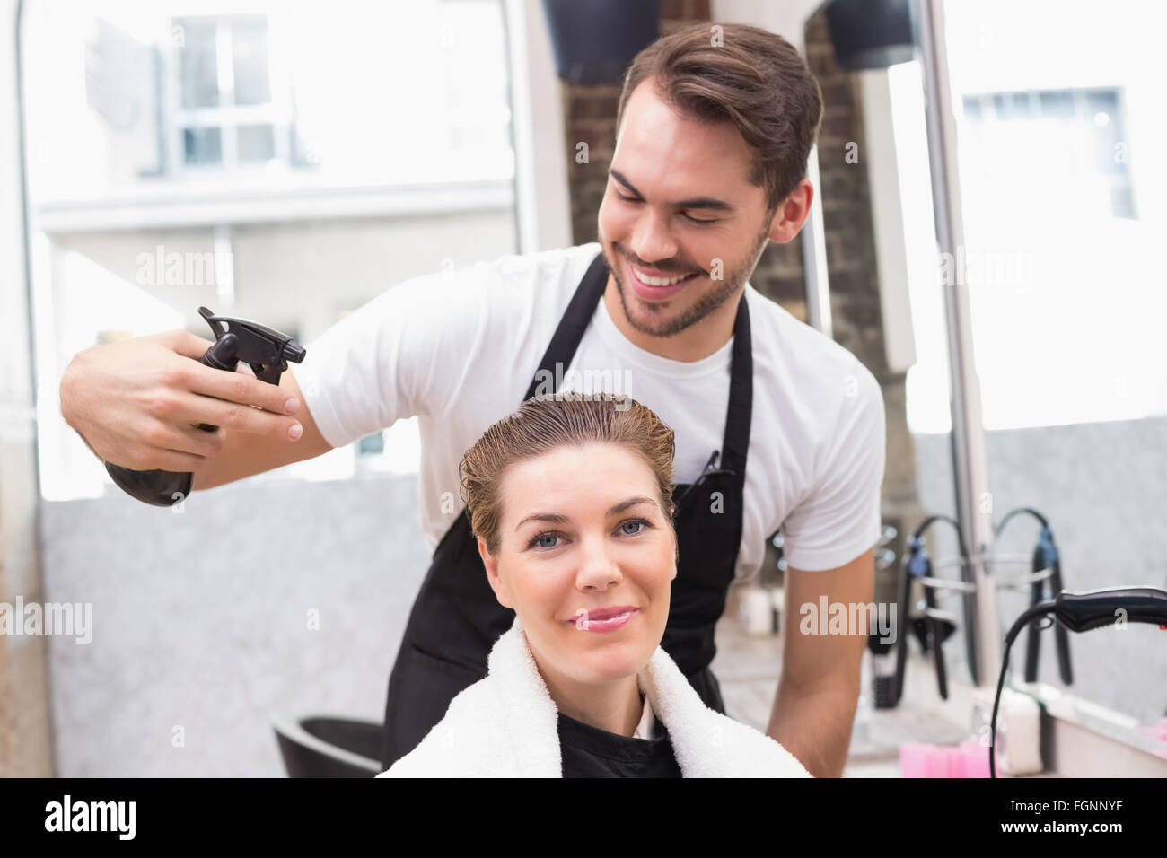 Handsome hair stylist with client Stock Photo - Alamy