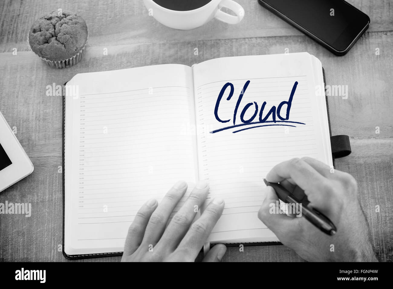 Cloud against man writing notes on diary Stock Photo - Alamy