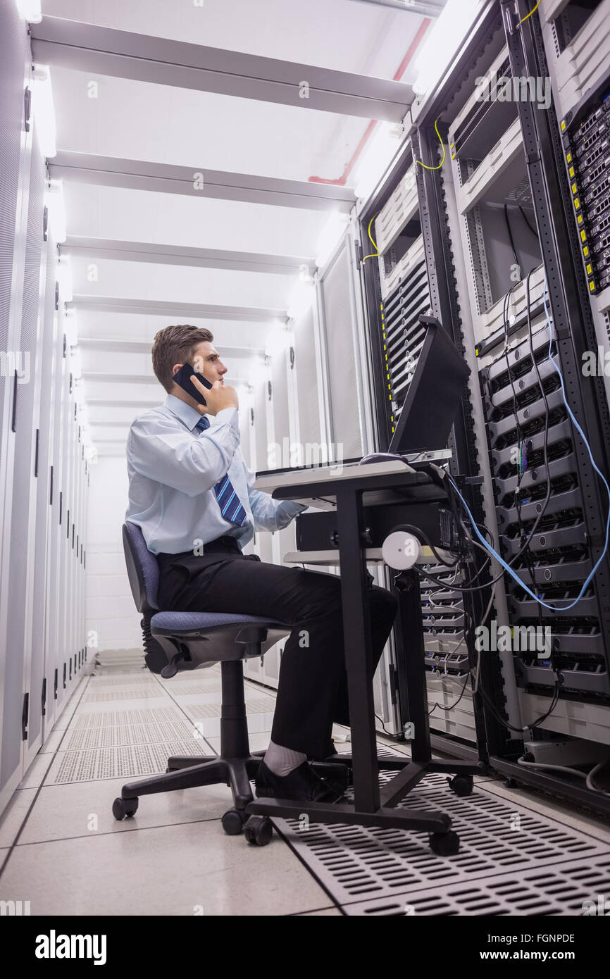 Technician talking on phone while looking servers Stock Photo Alamy