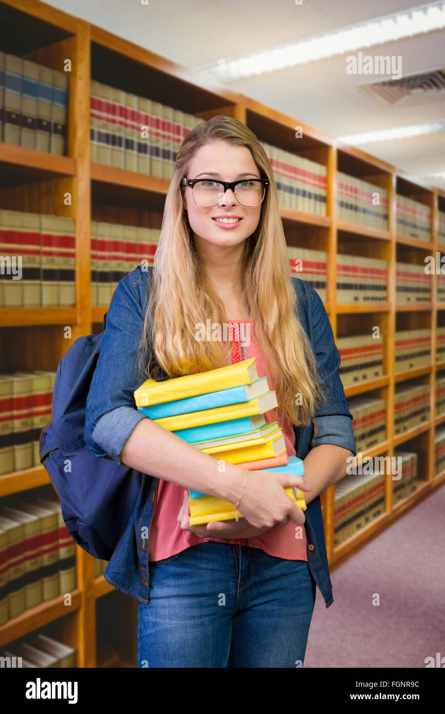 Composite image of pretty student in the library Stock Photo - Alamy