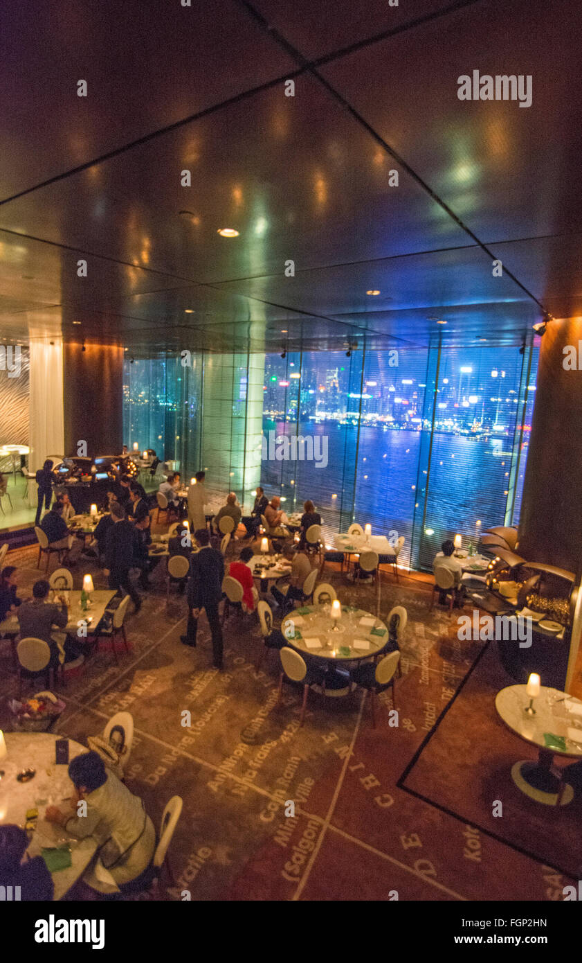 Hong Kong China Peninsula Hotel Felix Bar at night exclusive expensive restaurant with glass and city harbour at night at window Stock Photo