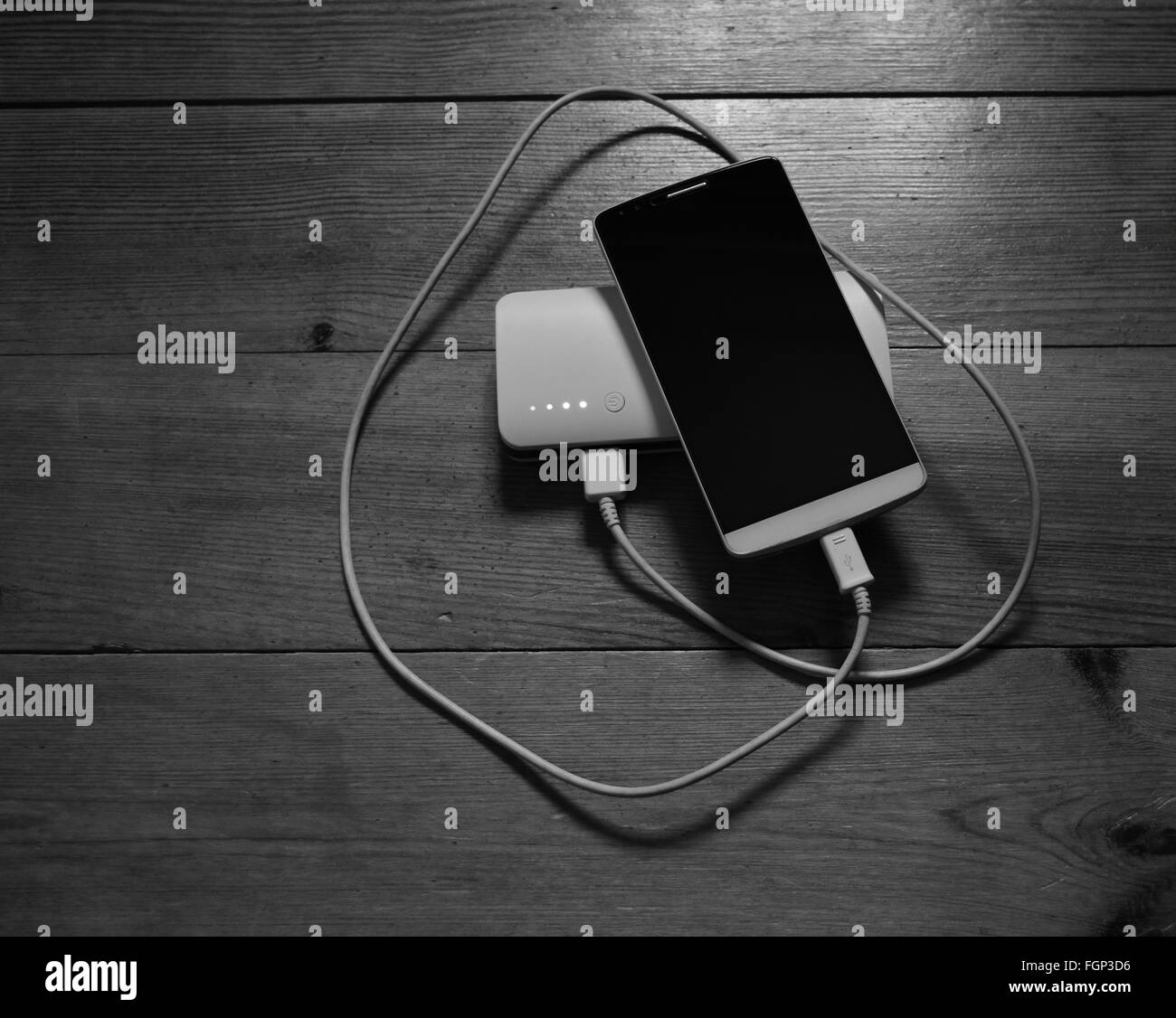 Smartphone and powerbank on wooden background Stock Photo