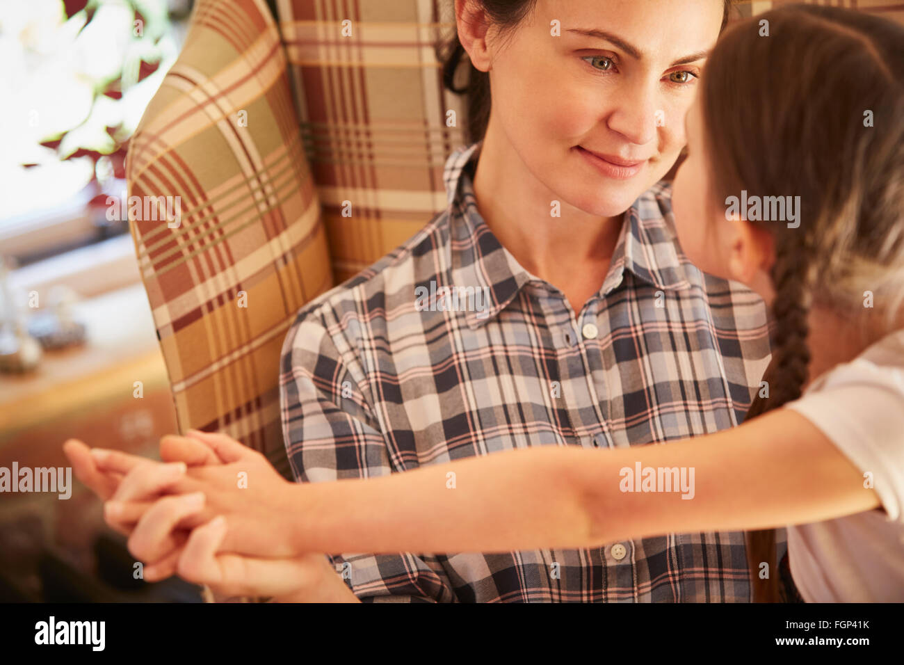 Mother and daughter holding hands face to face Stock Photo