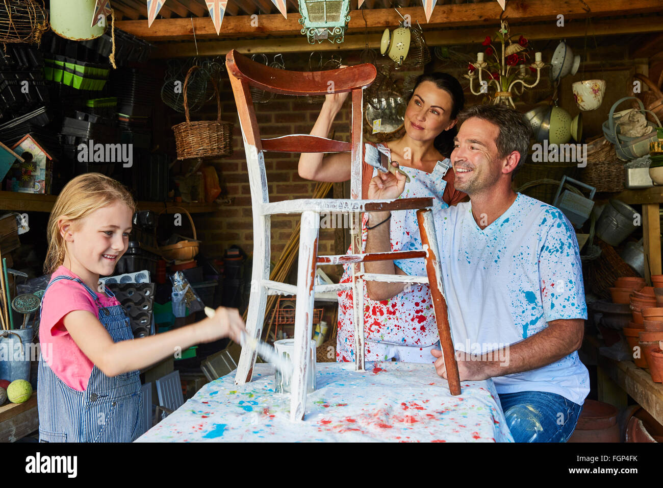 Family painting chair in workshop Stock Photo