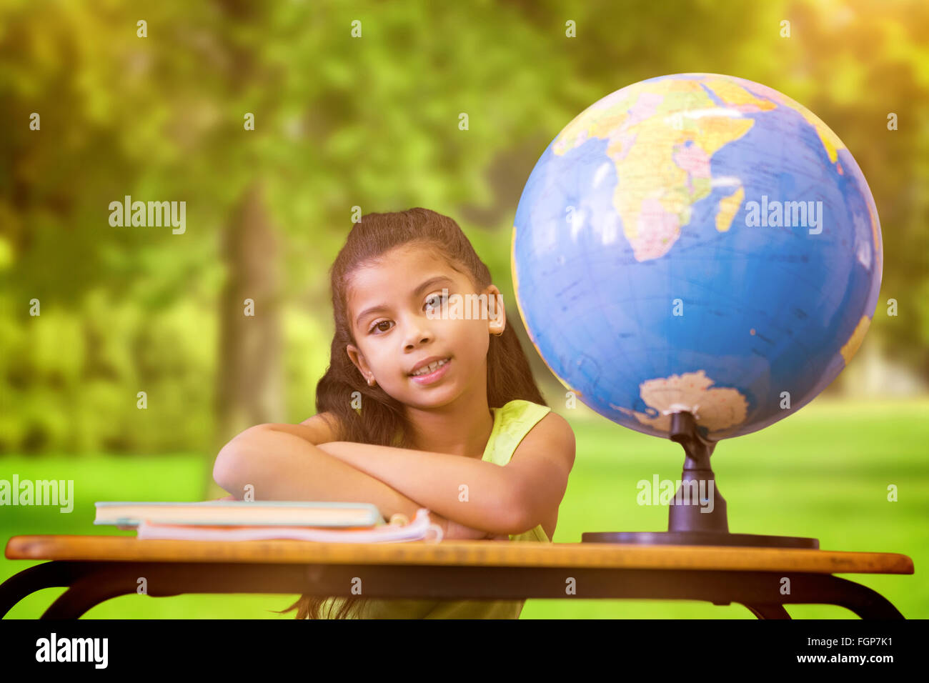 Composite image of cute pupils sitting at desk Stock Photo - Alamy