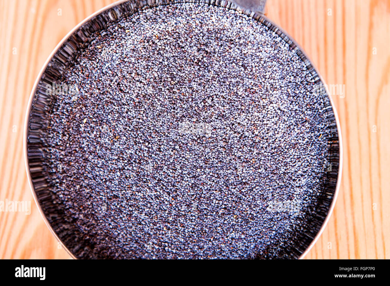 Poppy seeds in bowl Stock Photo