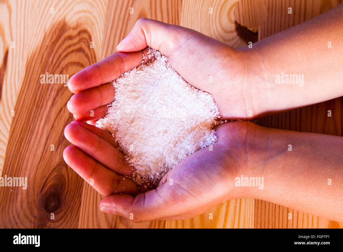 Coconut flakes held in hands Stock Photo Alamy