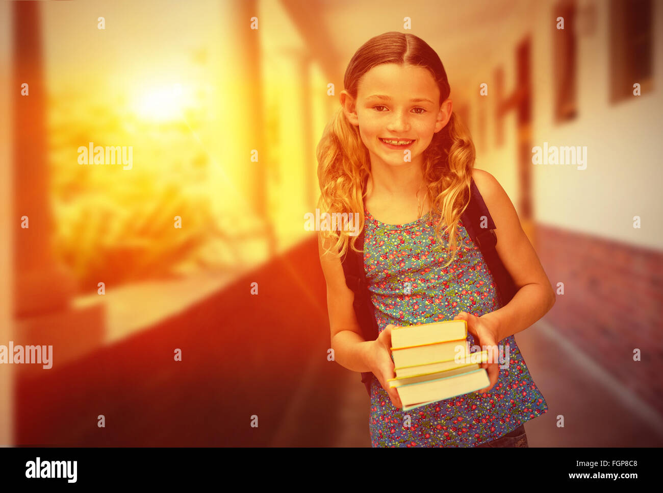 Composite image of cute little girl holding books in library Stock ...