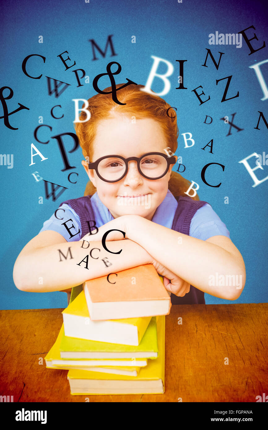 Composite image of cute pupil at desk Stock Photo - Alamy