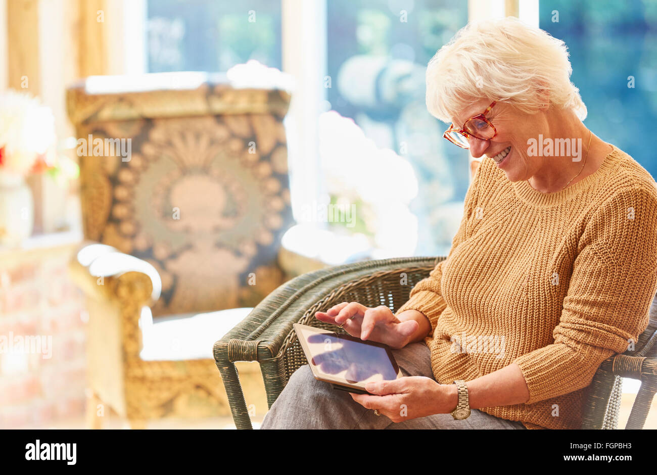Senior woman using digital tablet Stock Photo