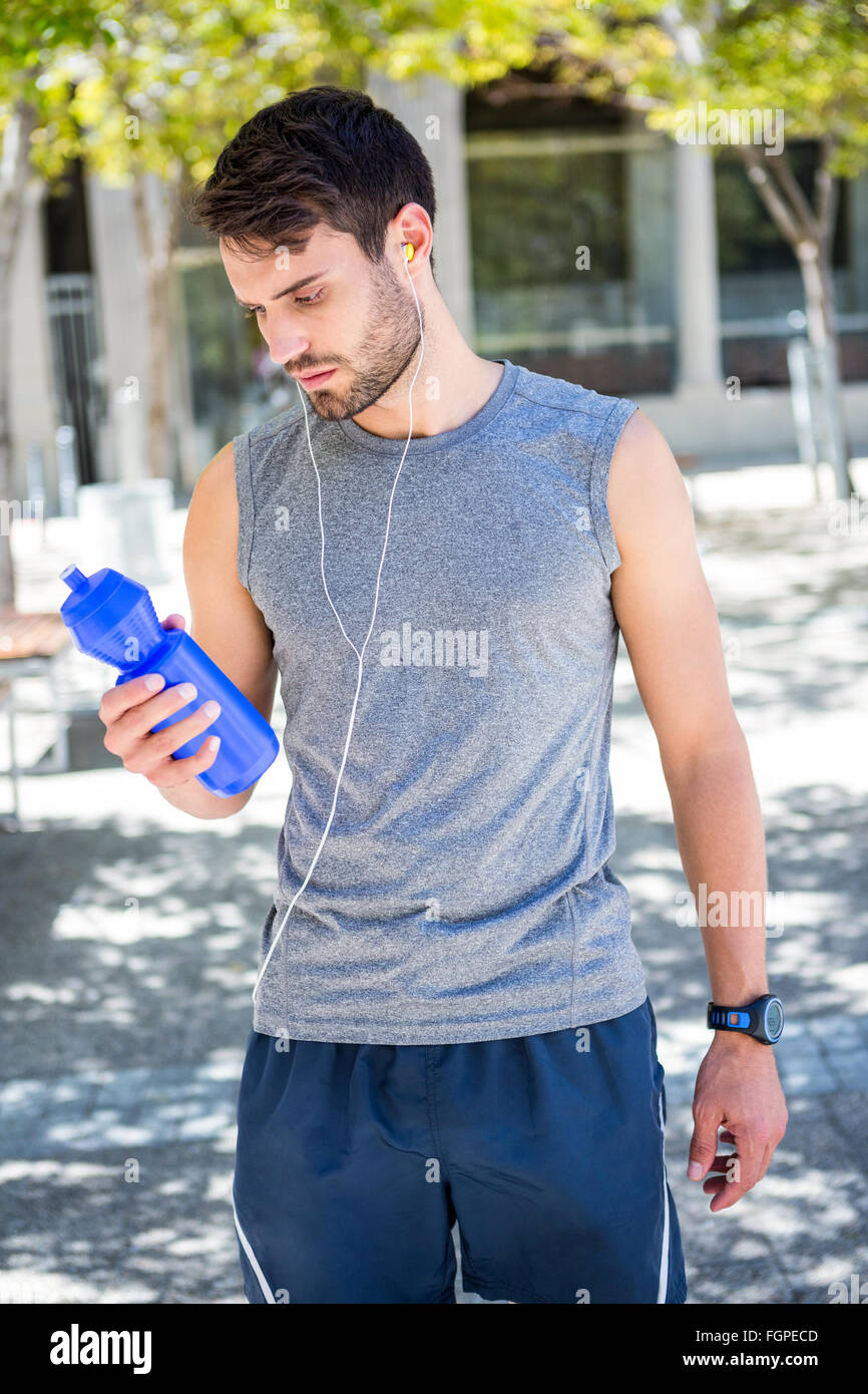 Handsome runner holding a water bottle Stock Photo - Alamy