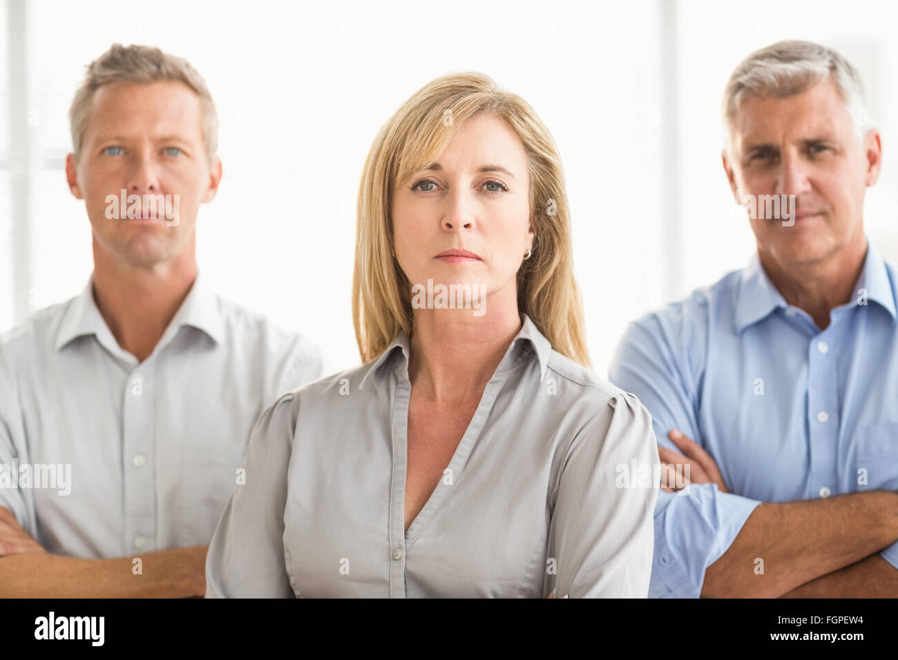 Serious casual business people with arms crossed Stock Photo - Alamy