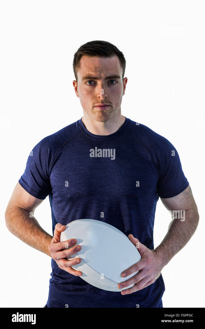 Attentive man holding a rugby ball Stock Photo Alamy