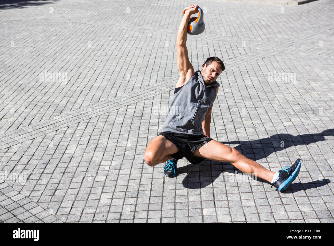Handsome athlete exercising turkish get up Stock Photo
