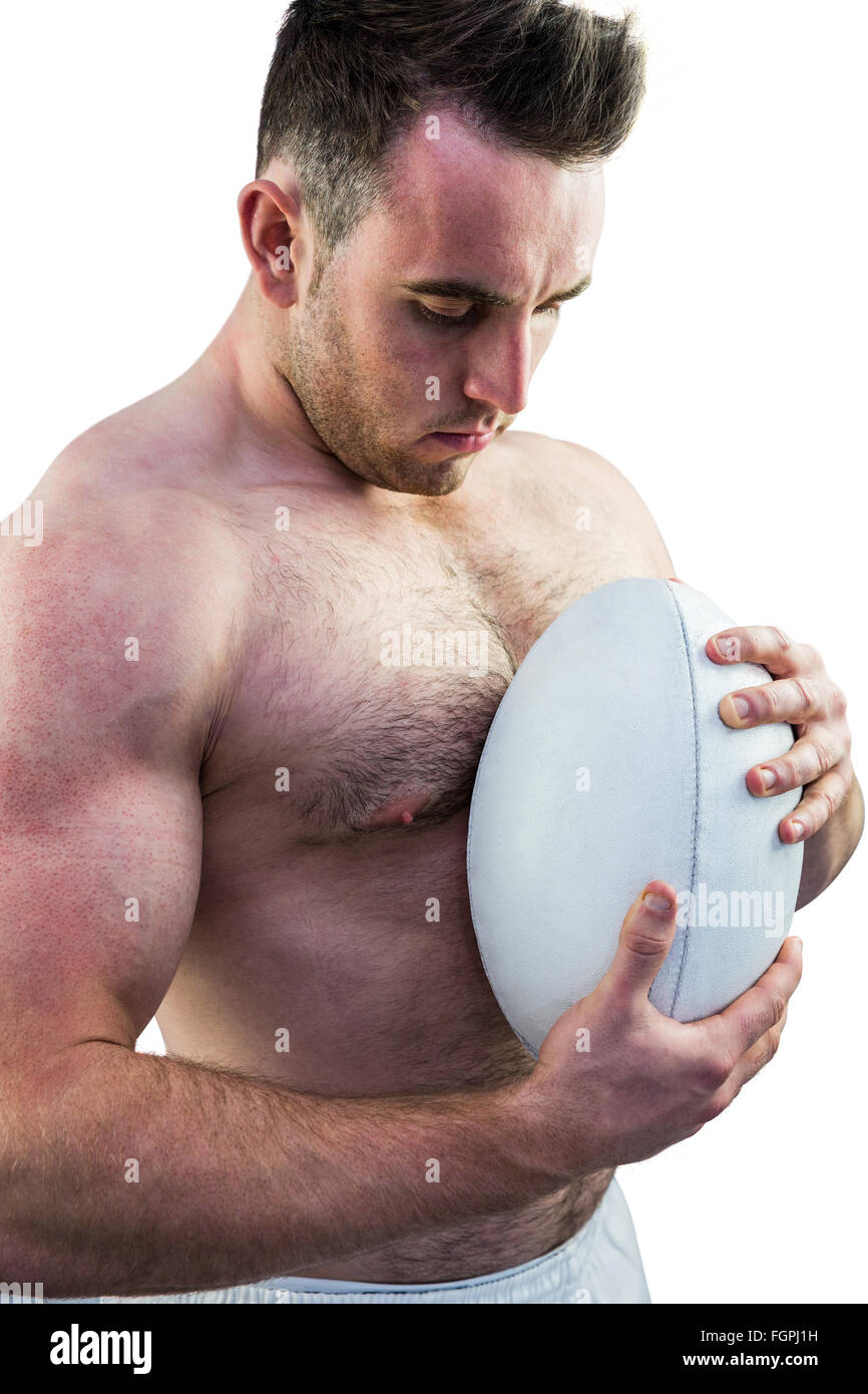 Shirtless rugby player holding ball Stock Photo Alamy