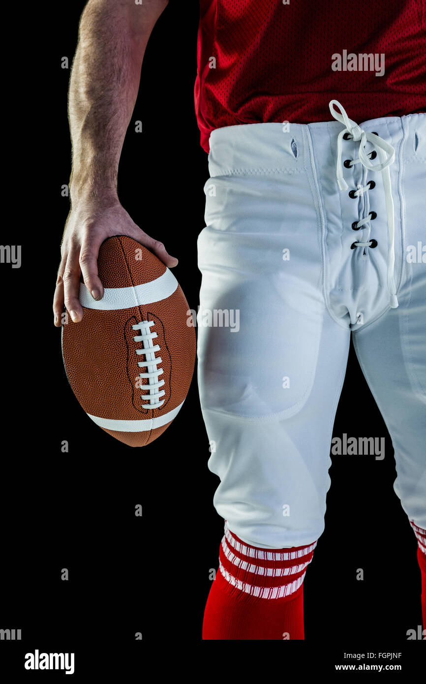 American football player holding football Stock Photo Alamy
