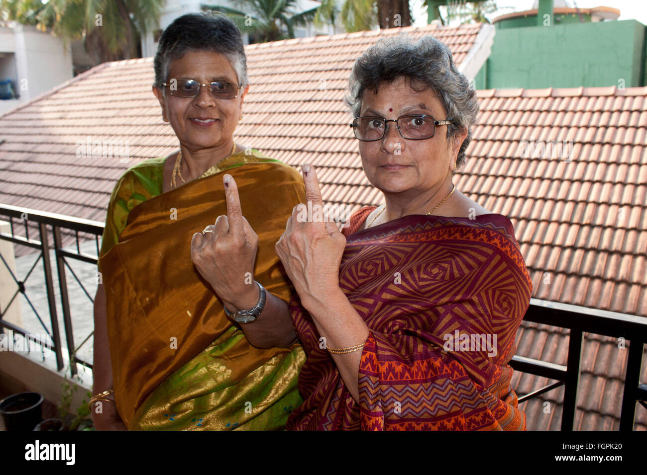 Old indian women showing the ink mark on their fingers after voting, Karnataka, India Stock Photo