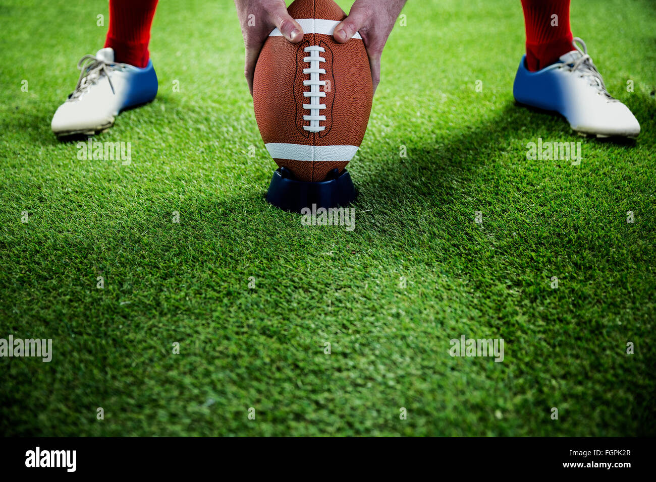 American football player preparing for a drop kick Stock Photo Alamy