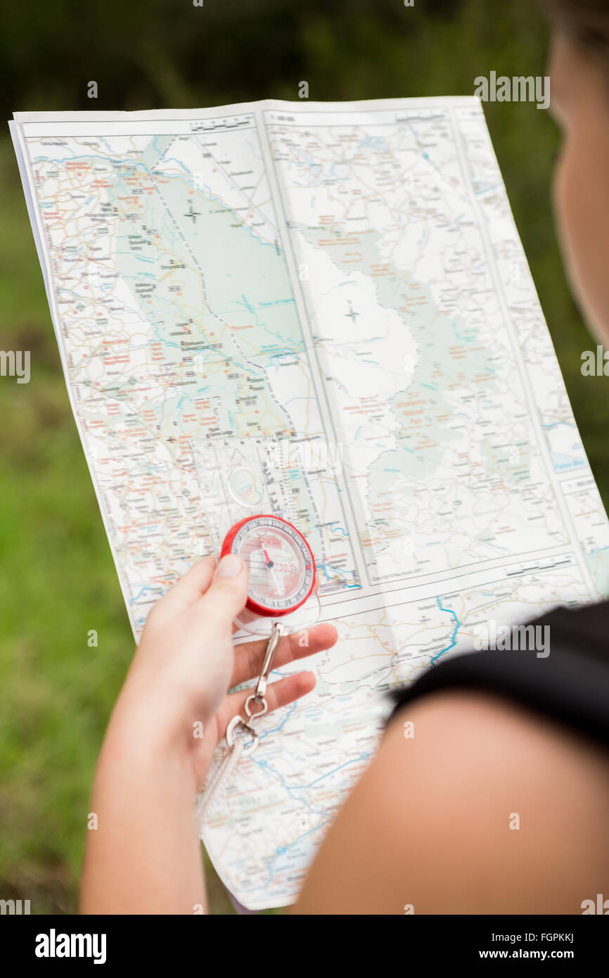 Female hiker with compass and reading map Stock Photo - Alamy