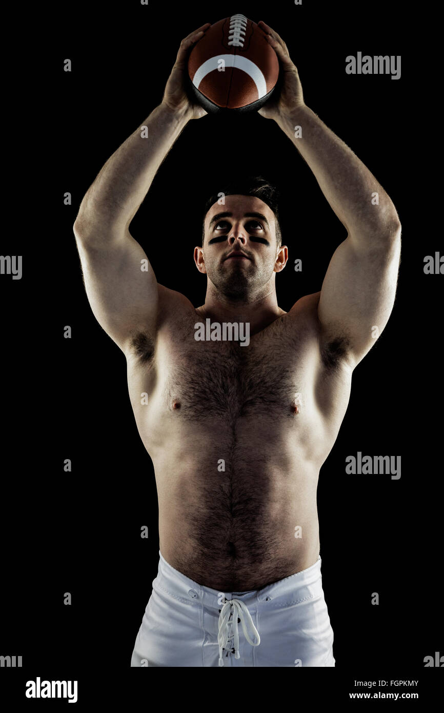 Shirtless American football player with ball Stock Photo Alamy