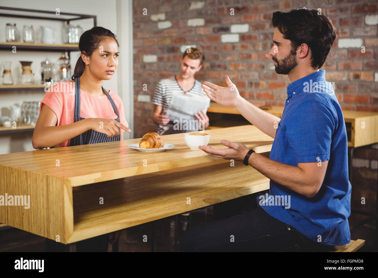 Unhappy customer complaining about the croissant Stock Photo