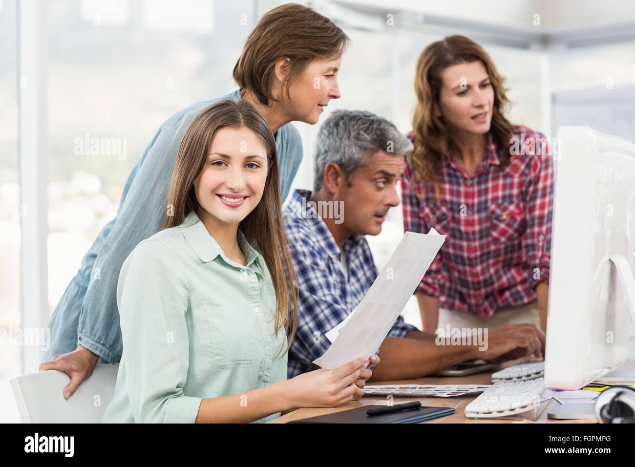 Colleague Computer Four casual colleagues using computer Stock Photo - Alamy