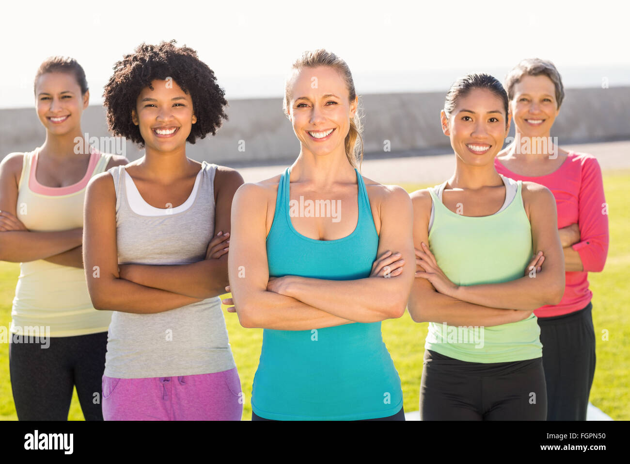 Smiling sporty women with arms crossed Stock Photo - Alamy