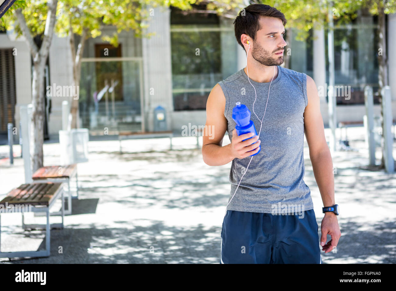 Handsome runner holding a water bottle Stock Photo - Alamy