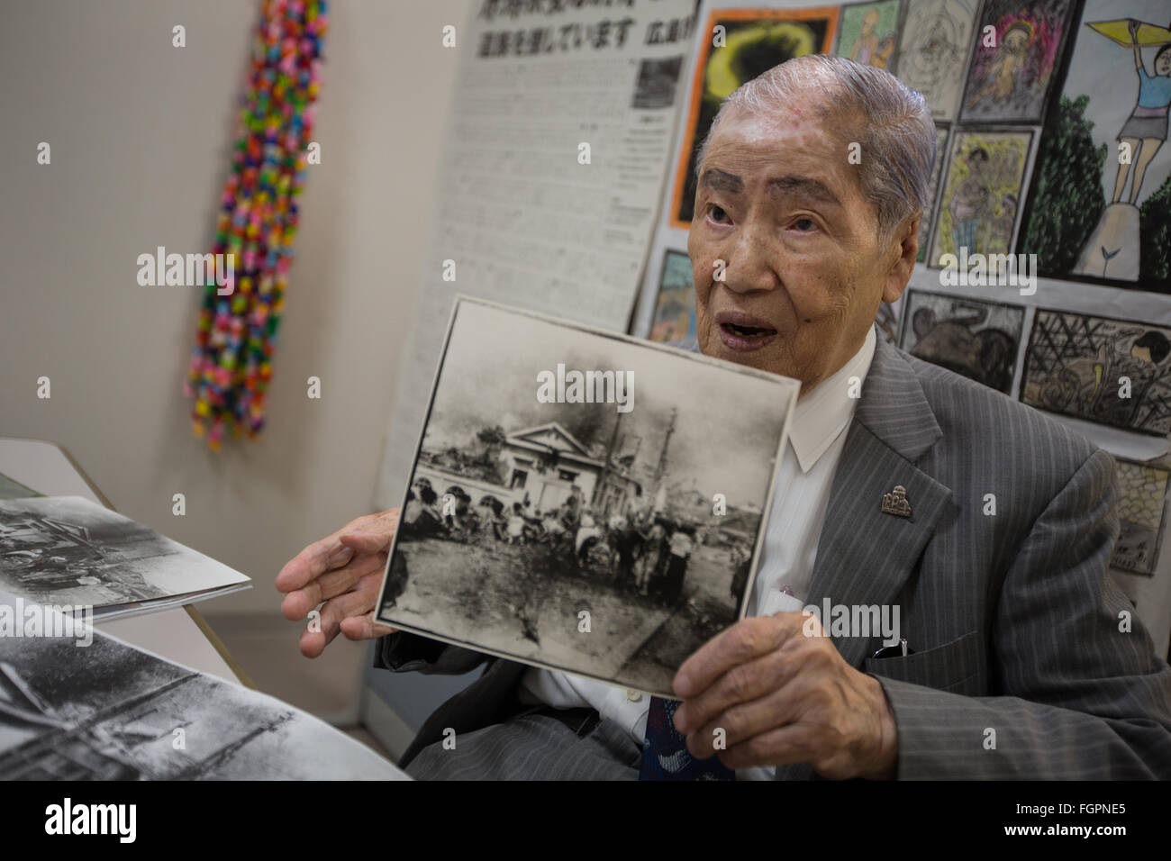 Sunao Tsuboi, atomic bomb survivor and co-Chairperson of the Japan Confederation of A- and H- bomb Sufferers Organisation, in 8 July 2015.  Photographed holding an image taken shortly after the Hiroshima bombing and in which he appears. Stock Photo