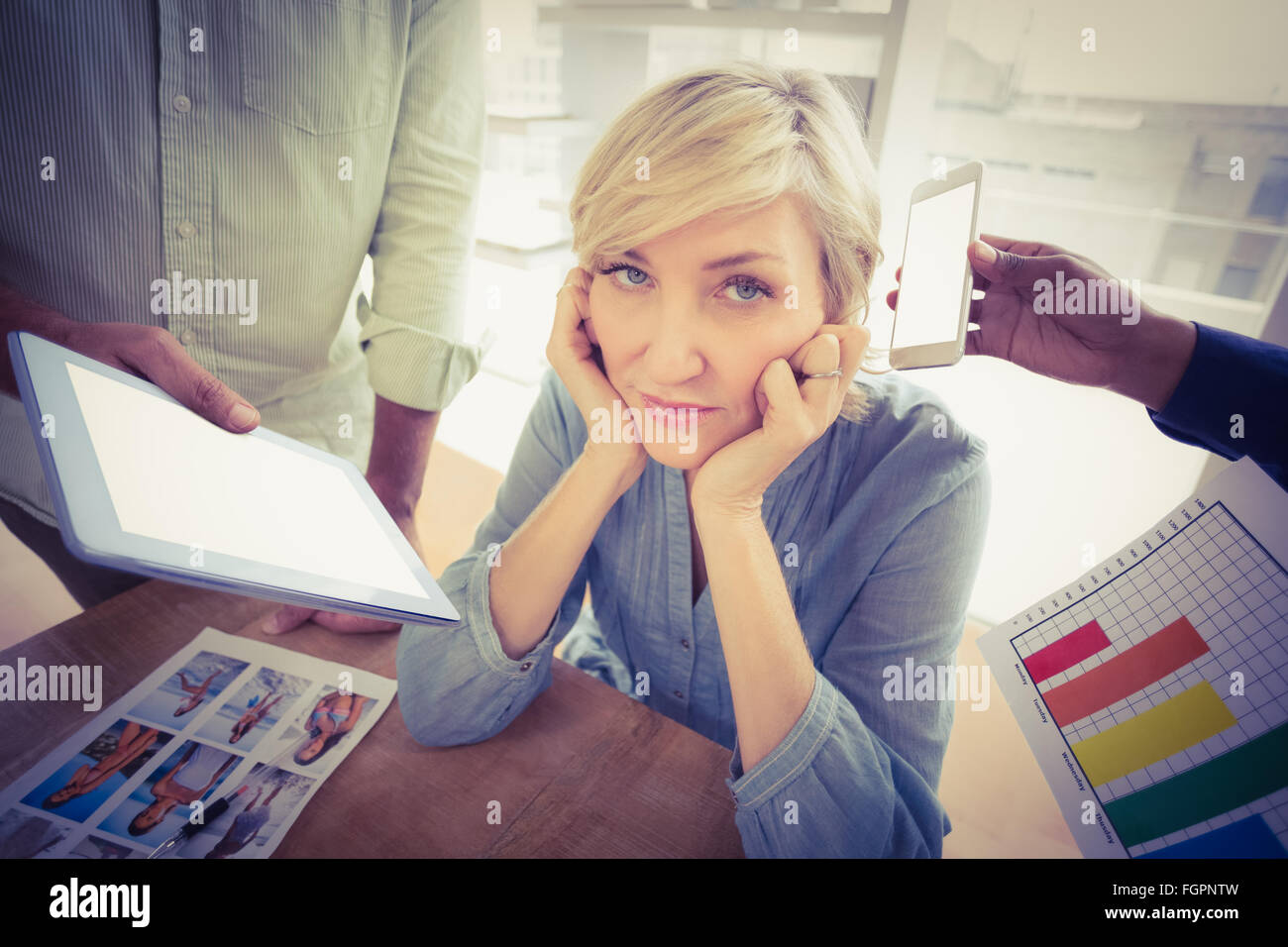 Overwrought businesswoman covering her ears Stock Photo