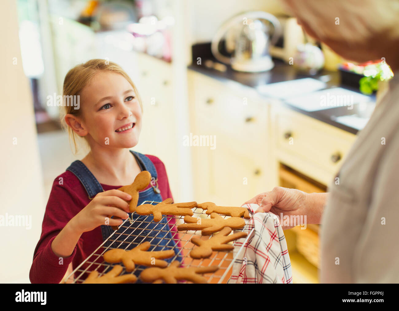 Grandmother and granddaughter baking gingerbread cookies Stock Photo