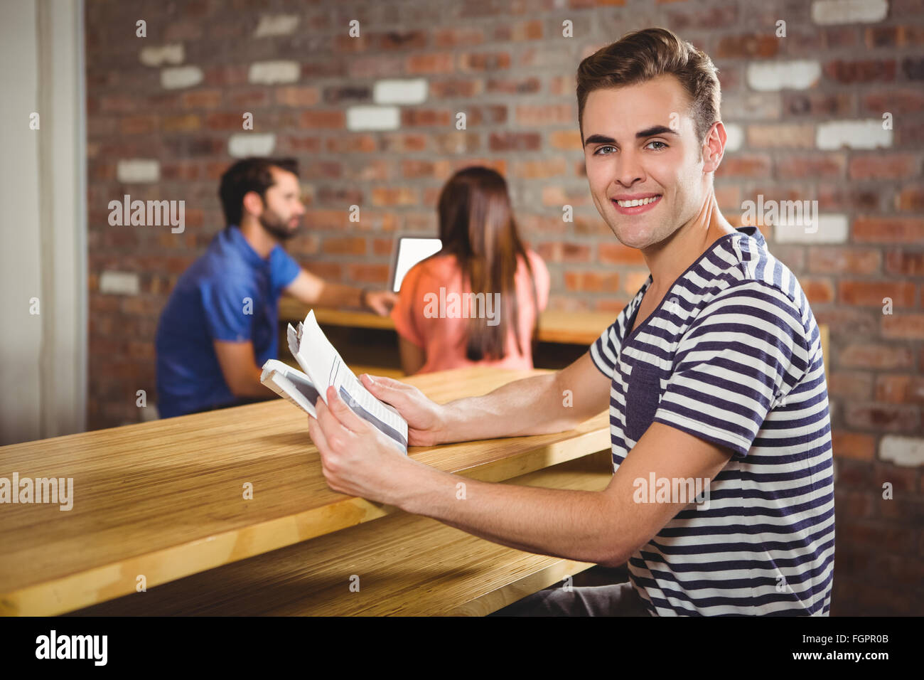 Young man reading a newspaper Stock Photo - Alamy