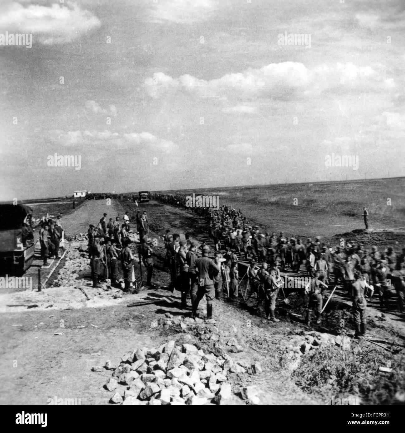 Second World War / WWII, Soviet Union, summer 1941, members of a Reichsarbeitsdienst (Reich Labor Service) unit, deployed on the Eastern Front (Abteilung K. 1/130), working on a road, column of Soviet prisoners of war marching by, Additional-Rights-Clearences-Not Available Stock Photo