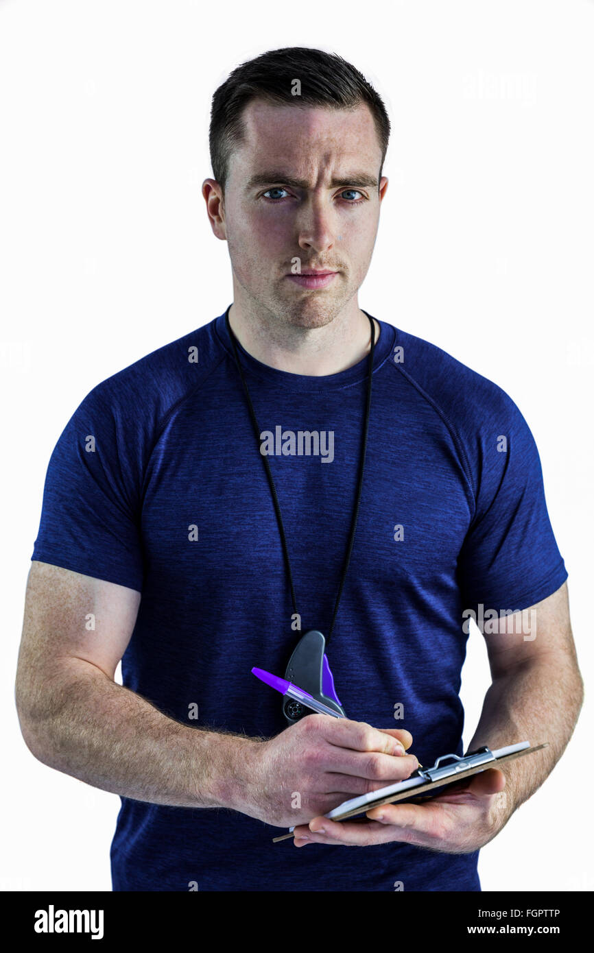 Attentive trainer writing on his clipboard Stock Photo - Alamy