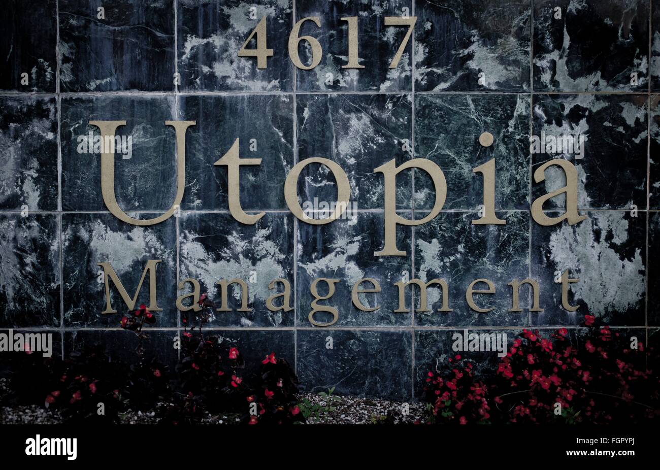 Weathered sign board of the Utopia Management, in February 2016. Stock Photo